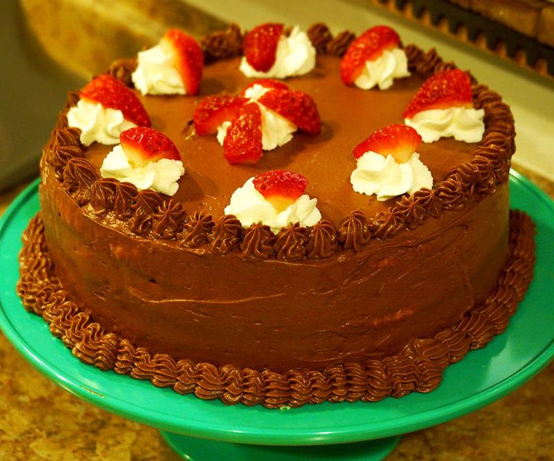 A chocolate layer cake with strawberries