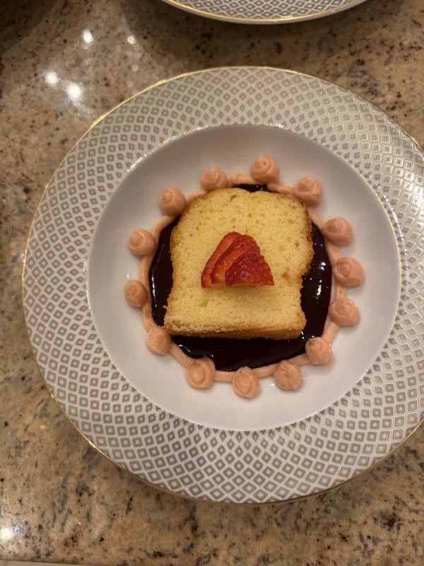 A dessert served on gold-rimmed china