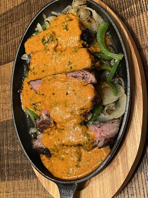 A sizzling skillet of spiced steak