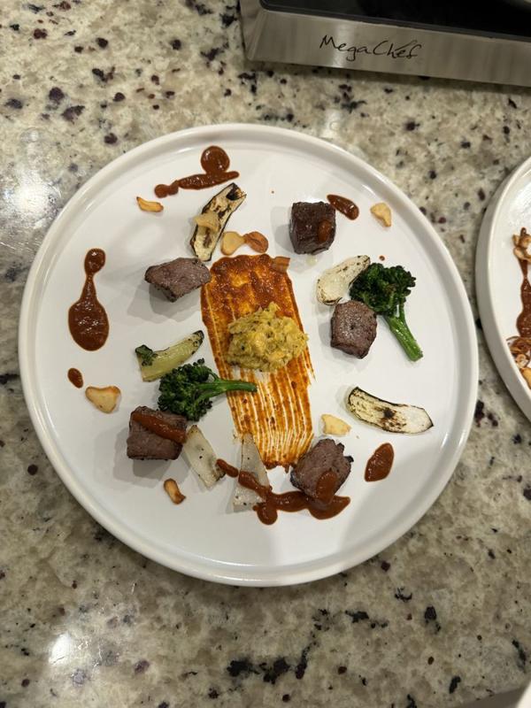 Salmon and beef duo plated fine dining style